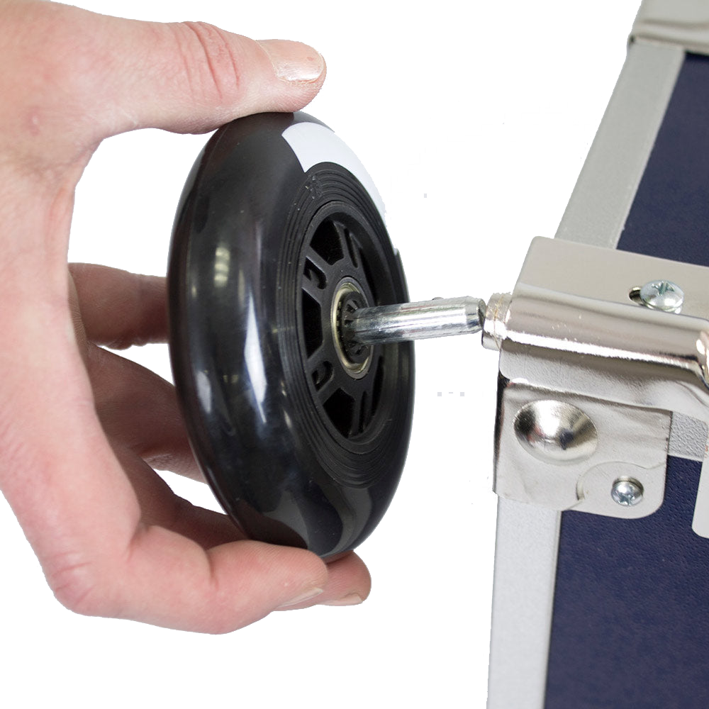 Hand holding a wheel attached to a piece of equipment with a white background